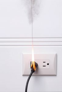 Burning cord in electrical outlet